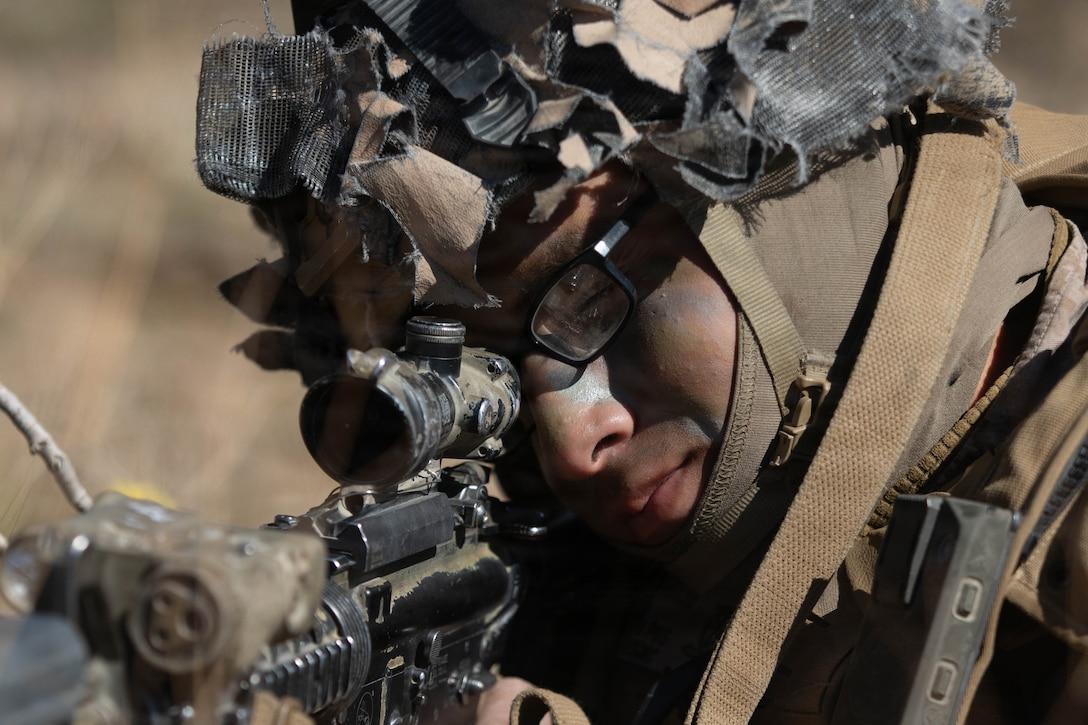 U.S. Marine Corps Lance Cpl. Diego Peralta, an intelligence specialist with Lima Company, 3rd Battalion, 7th Marine Regiment, 1st Marine Division, holds security during a service level training exercise at Marine Corps Air-Ground Combat Center, Twentynine Palms, California, Feb. 19, 2026. SLTE is designed to be a challenging, realistic training environment that produces combat-ready forces capable of operating as an integrated Marine Air-Ground Task Force across all domains of military operations. Peralta is a native of California. (U.S. Marine Corps photo by Cpl. Keegan Jones)