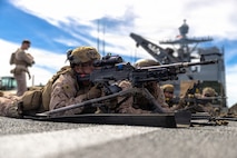 A U.S. Marine, with Kilo Company, Battalion Landing Team 3/5, 11th Marine Expeditionary Unit, notionally fires an M240B machine gun as part of weapon manipulation training aboard Whidbey Island-class dock landing ship USS Comstock (LSD 45) in the Pacific Ocean, Feb. 24, 2026. The 11th MEU is currently underway aboard the Boxer Amphibious Ready Group in the U.S. 3rd Fleet area of operations conducting integrated training that enhances lethality and warfighting readiness. (U.S. Marine Corps photo by Sgt. Trent A. Henry)