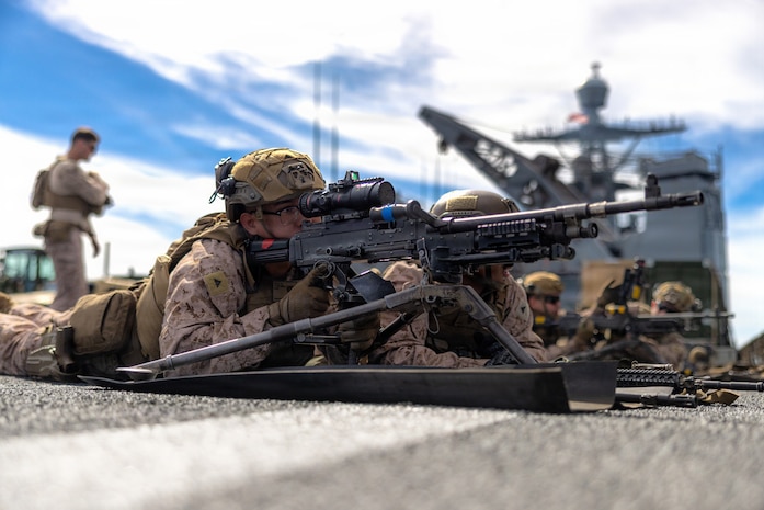 A U.S. Marine, with Kilo Company, Battalion Landing Team 3/5, 11th Marine Expeditionary Unit, notionally fires an M240B machine gun as part of weapon manipulation training aboard Whidbey Island-class dock landing ship USS Comstock (LSD 45) in the Pacific Ocean, Feb. 24, 2026. The 11th MEU is currently underway aboard the Boxer Amphibious Ready Group in the U.S. 3rd Fleet area of operations conducting integrated training that enhances lethality and warfighting readiness. (U.S. Marine Corps photo by Sgt. Trent A. Henry)