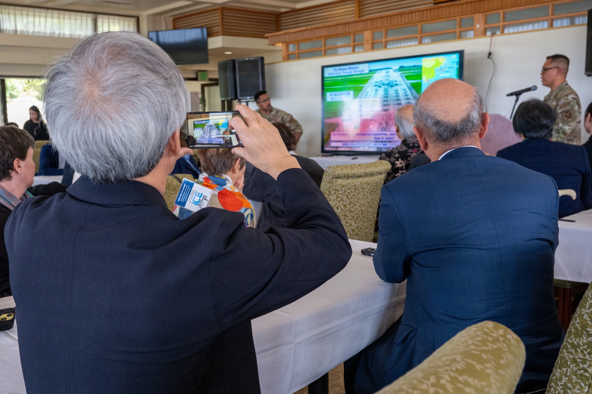 person takes photo of slides on his phone