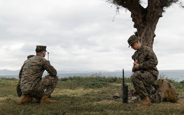 U.S. Marines with 5th Air Naval Gunfire Liaison Company, III Marine Expeditionary Force Information Group, set up transmission assets during a communication exercise at Camp Courtney, Okinawa, Japan, Feb. 11, 2026.