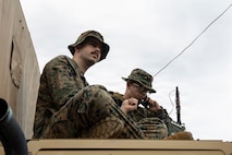 U.S. Marine Corps Lance Cpl. Samuel Rockney, left, a native of California and a network administrator, and Lance Cpl. Taren Clemons, a native of Connecticut and a transmissions system operator, both with 5th Air Naval Gunfire Liaison Company, III Marine Expeditionary Force Information Group, conduct radio checks during a communication exercise at Camp Courtney, Okinawa, Japan, Feb. 11, 2026.