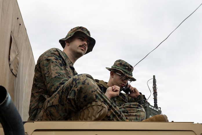 U.S. Marine Corps Lance Cpl. Samuel Rockney, left, a native of California and a network administrator, and Lance Cpl. Taren Clemons, a native of Connecticut and a transmissions system operator, both with 5th Air Naval Gunfire Liaison Company, III Marine Expeditionary Force Information Group, conduct radio checks during a communication exercise at Camp Courtney, Okinawa, Japan, Feb. 11, 2026.