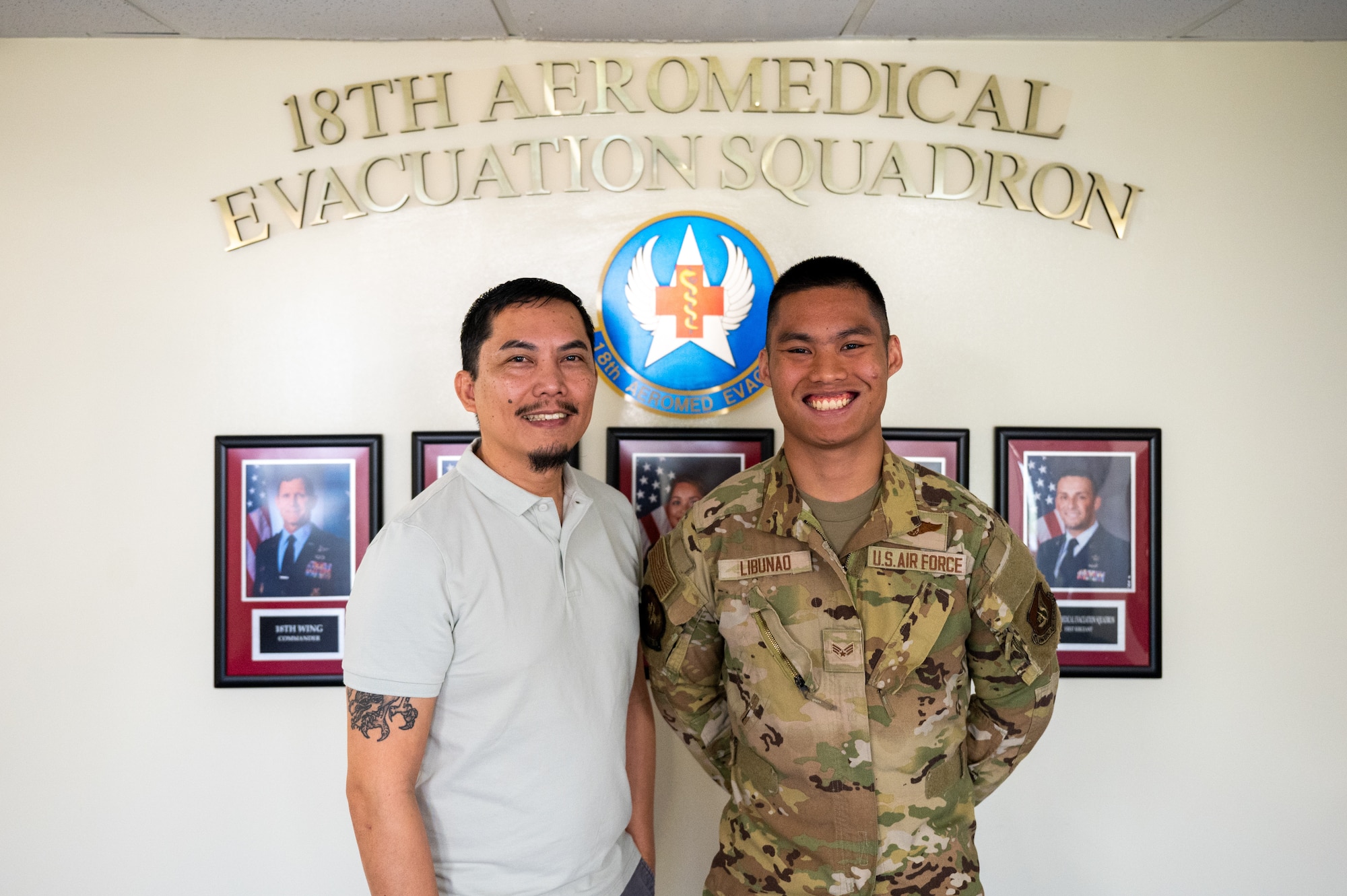 U.S. Air Force Senior Airman Angelo Libunao, 18th Aeromedical Evacuation Squadron AE technician, right, stands alongside his father, retired Senior Master Sgt. Jose Libunao, at Kadena Air Base, Feb. 19, 2026. Libunao is the third member of his family to serve in the 18th AES, continuing a legacy of aeromedical evacuation service at Kadena. (U.S. Air Force photo by Airman 1st Class Francisco Huerta)