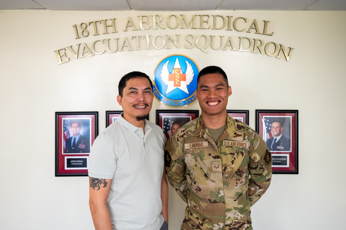 U.S. Air Force Senior Airman Angelo Libunao, 18th Aeromedical Evacuation Squadron AE technician, right, stands alongside his father, retired Senior Master Sgt. Jose Libunao, at Kadena Air Base, Feb. 19, 2026. Libunao is the third member of his family to serve in the 18th AES, continuing a legacy of aeromedical evacuation service at Kadena. (U.S. Air Force photo by Airman 1st Class Francisco Huerta)