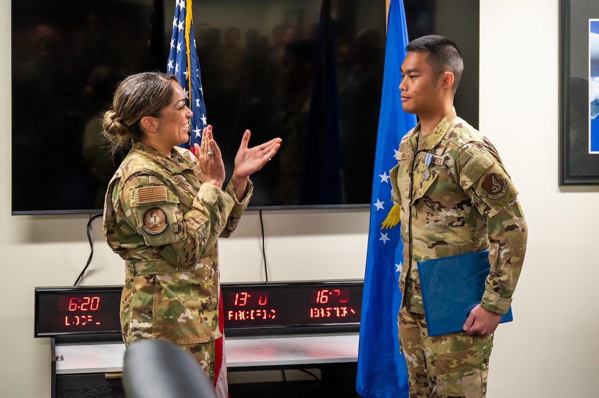 U.S. Air Force Col. Jeanae Jackson, 18th Aeromedical Evacuation Squadron commander, congratulates Senior Airman Angelo Libunao during a ceremony at Kadena Air Base, Feb. 19, 2026. The event recognized Libunao’s achievements from his previous assignment and welcomed him to the 18th AES. (U.S. Air Force photo by Airman 1st Class Francisco Huerta)