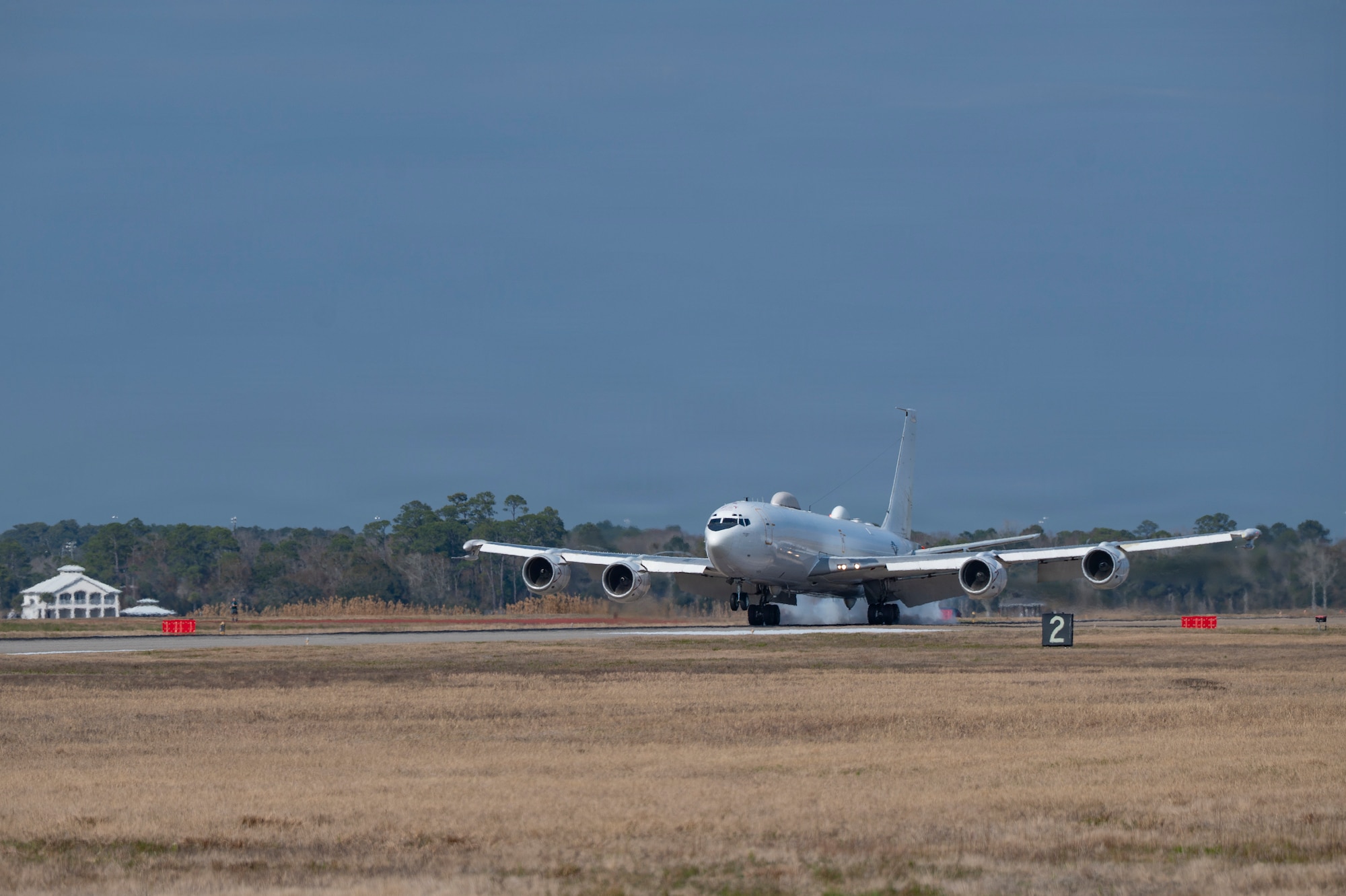 A white plane on a runway.