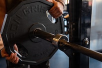 Patron adds weight to barbell