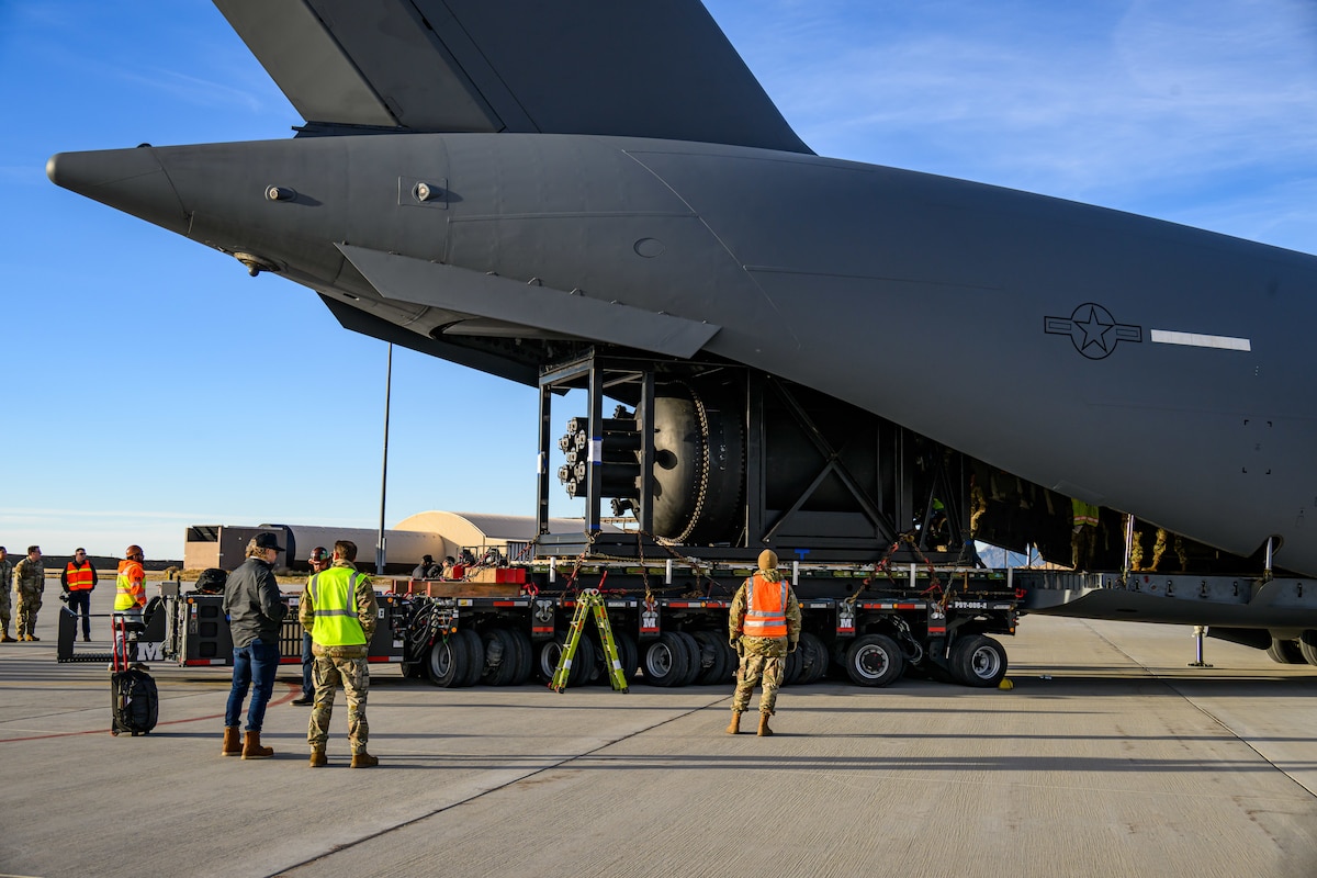 Airmen unload nuclear reactor components from a C-17 Globemaster III at Hill Air Force Base, Utah, Feb. 15, 2026. The Air Force, in coordination with the Department of Energy and Valar Atomics, airlifted the reactor aboard a C-17 from March Air Reserve Base, Calif., to Hill AFB. The reactor will be transported to the Utah San Rafael Energy Lab for testing and evaluation. (U.S. Air Force photo by R. Nial Bradshaw)