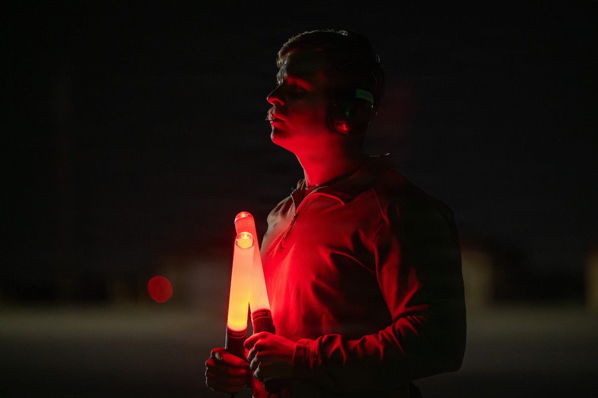 Senior Airman Zachariah Tucker, 95th Fighter Generation Squadron crew chief, prepares to marshal an F-35A Lightning II during exercise Bamboo Eagle 26-1 at Marine Corps Air Station Yuma, Ariz., Feb. 17, 2026. The exercise provides Airmen with the opportunity to operate from austere locations, demonstrating flexibility and endurance required to sustain combat power and ensure survivability in dynamic conditions. (U.S. Air Force photo by Airman 1st Class Amanda Alvarez)