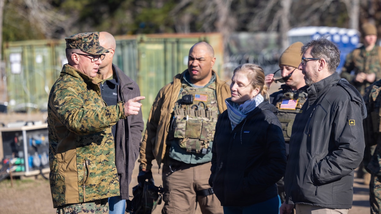 U.S. Marine Corps Col. Ryan A. Lynch, left, commanding officer of the 24th Marine Expeditionary Unit, speaks to Department of State personnel on MEU capabilities during a visit to Marine Corps Auxiliary Landing Field Bogue, North Carolina, Feb. 24, 2026. The visit was a part of the 24th MEU’s certification exercise, a land-based pre-deployment exercise that enhances the integration and collective capability of the Marine Air-Ground Task Force while providing the opportunity to train and execute operations in austere and urban environments.   (U.S. Marine Corps photo by Lance Cpl. Brian Bolin Jr.)