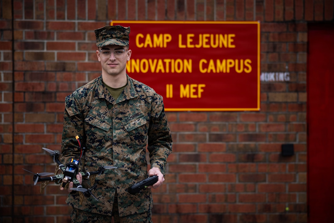 U.S. Marine Corps Sgt. Henry David Volpe, an automotive maintenance technician with 2nd Maintenance Battalion, 2nd Combat Readiness Regiment, 2nd Marine Logistics Group, poses for a photo with the HANX drone at Marine Corps Base Camp Lejeune, North Carolina, Jan. 23, 2026. The HANX is the Marine Corps' first National Defense Authorizing Act-compliant, 3D-printed drone, providing a secure and adaptable aerial platform for the modern warfighter. (U.S. Marine Corps photo by Sgt. Alfonso Livrieri)