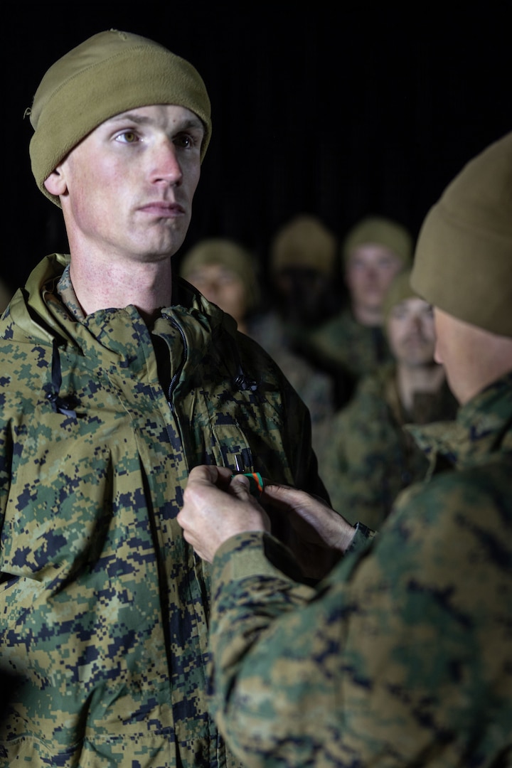 U.S. Marine Corps 1st Lt. Connor Rooney, left, a logistics officer with Combat Logistics Battalion 24, Combat Logistics Regiment 27, 2nd Marine Logistics Group, is awarded the Navy and Marine Corps Achievement Medal during CLB-24's Warrior’s Night as part of Mountain Training Exercise 1-26 at Marine Corps Mountain Warfare Training Center in Bridgeport, California, Feb. 10, 2026. Warrior’s Night is a tradition that usually follows major training exercises and is held to build camaraderie and celebrate accomplishments while honoring unit history through ceremony, toasts, and shared activities. Exercises like MTX 1-26 prove Marines’ ability to provide flexible and responsive combat service support during high intensity combat operations in contested and mountainous terrain. Rooney is a native of Illinois.