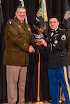 Brig. Gen. Lenny Williams, the Assistant Adjutant General – Army of the Illinois National Guard and Commander of the Illinois Army National Guard, presents Staff Sgt. Nathaniel Ramos with the Illinois Army National Guard Recruiting and Retention Battalion “Rookie of the Year” Award at the battalion’s annual Military Ball and Awards Ceremony, Jan. 31, in Springfield.
