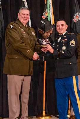 Brig. Gen. Lenny Williams, the Assistant Adjutant General – Army of the Illinois National Guard and Commander of the Illinois Army National Guard, presents Staff Sgt. Nathaniel Ramos with the Illinois Army National Guard Recruiting and Retention Battalion “Rookie of the Year” Award at the battalion’s annual Military Ball and Awards Ceremony, Jan. 31, in Springfield.