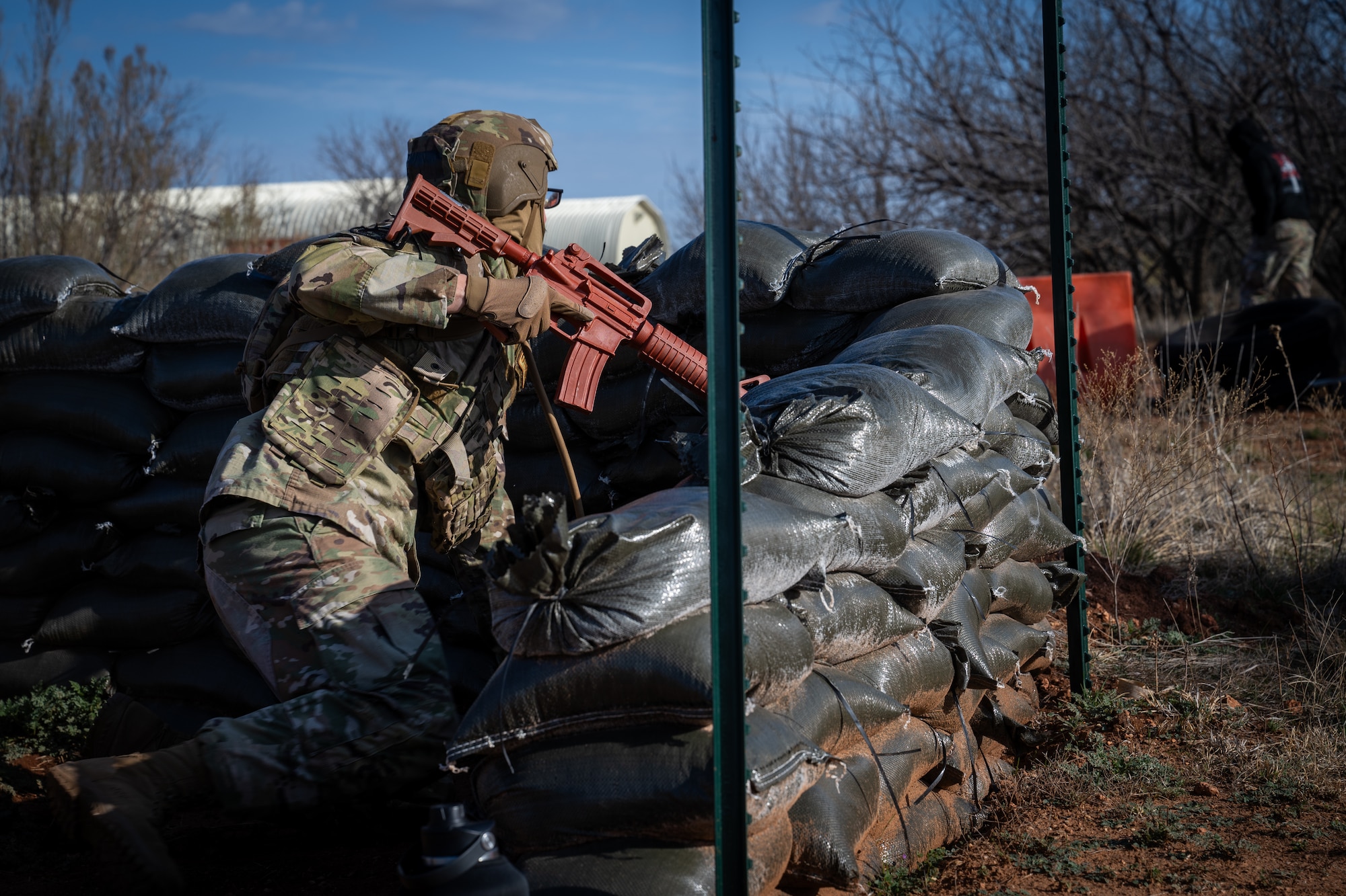 U.S. Air Force Staff Sgt. Dakota Wolford, 21st Air Task Force heating, ventilation and air conditioning journeyman, holds down a defensive position for a field training event during exercise Bamboo Eagle 26-1 at Dyess Air Force Base, Texas, Feb. 20, 2026.  The training reinforced force protection skills in austere environments by emphasizing threat detection, perimeter security and defensive response measures with limited infrastructure support. (U.S. Air Force photo by Airman 1st Class Adrien Tran)
