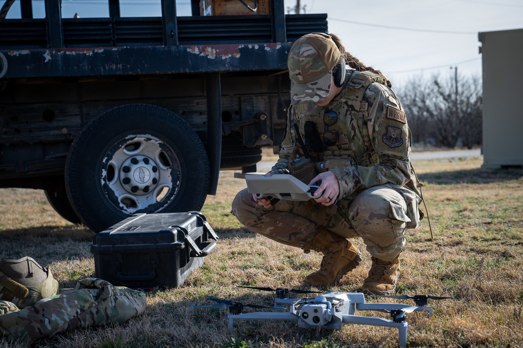 U.S. Air Force Staff Sgt. Rikki Nye, 21st Combat Air Base Squadron noncommissioned officer in charge of water and fuels maintenance, calibrates a small Unmanned Aircraft System for a field training event during exercise Bamboo Eagle 26-1 at Dyess Air Force Base, Texas, Feb. 20, 2026. The sUAS allows Airmen to conduct faster site assessments while minimizing risk to personnel. (U.S. Air Force photo by Airman 1st Class Adrien Tran)