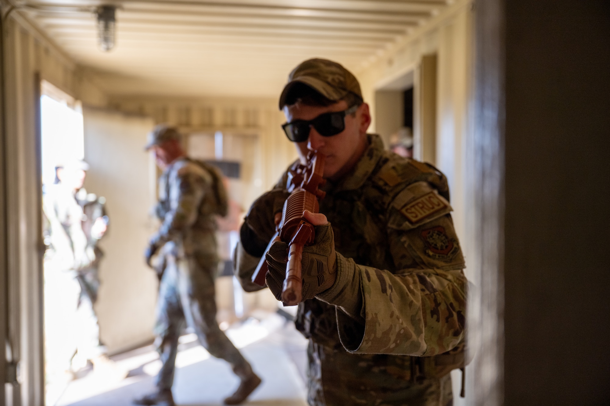 U.S. Air Force Senior Airman Brandon Sanislo, 21st Combat Air Base Squadron structural apprentice, stands guard at a doorway  in a close quarters battle training scenario during exercise Bamboo Eagle 26-1 at Dyess Air Force Base, Texas. Feb. 20, 2026.  CQB training was one of several skillsets practiced and tested during BE -26-1, validating the 21st CABS’s ability to conduct Agile Combat Employment operations. (U.S. Air Force photo by Airman 1st Class Adrien Tran)