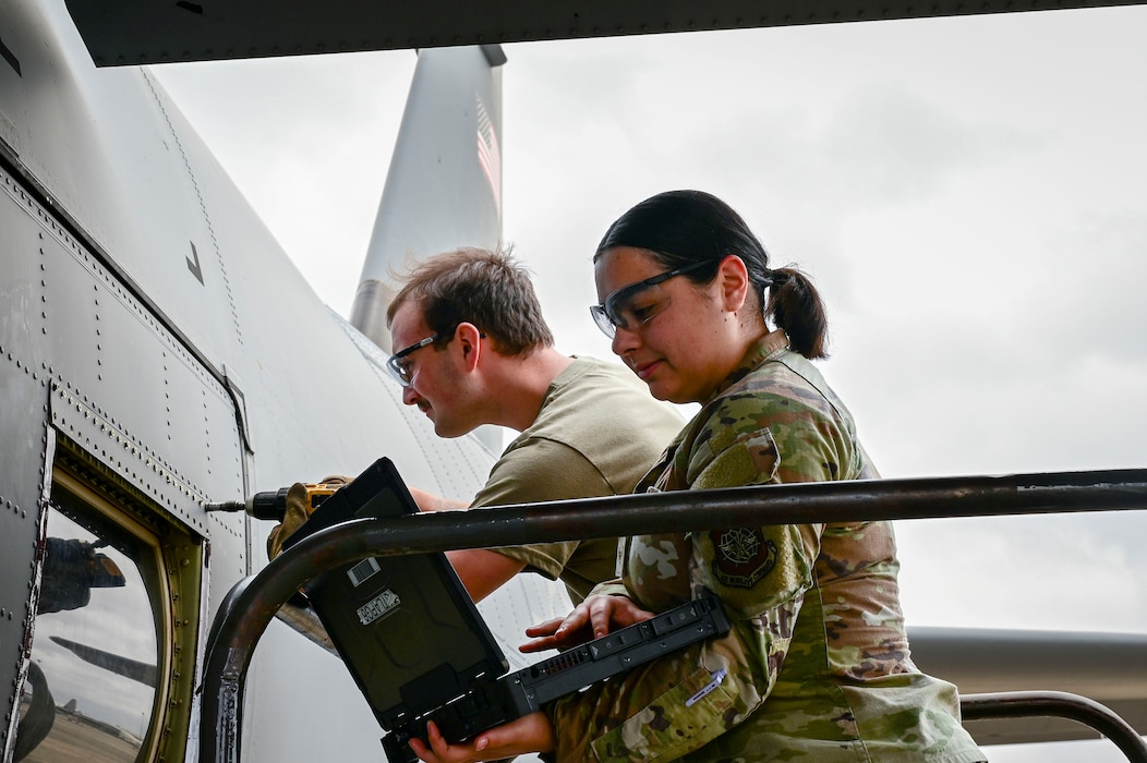 U.S. Air Force Airman 1st Class Ariana Alston, right, 19th Logistics Readiness Squadron customer service journeyman, assists Airman 1st Class Samuel Keenum, left, 19th Aircraft Maintenance Squadron C-130J journeyman crew chief, during a para-trooper door window repair on a C-130J Super Hercules aircraft at Little Rock Air Force Base, Arkansas, Feb. 17, 2026. The task was conducted as part of a Maintenance Supply Immersion Program designed to improve communication and strengthen teamwork between maintenance and materiel management personnel.