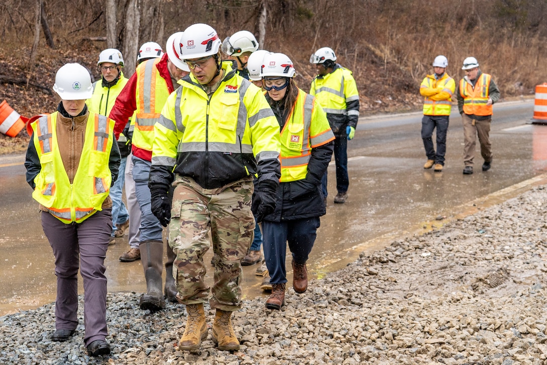 Group of people walk at construction site