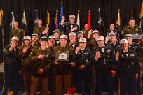 The Woodstock-based H Company “Honeybadgers” celebrate their “three-peat” as the Illinois Army National Guard Recruiting and Retention Battalion’s “Company of the Year” during the battalion’s annual awards banquet, Jan. 31, in Springfield.