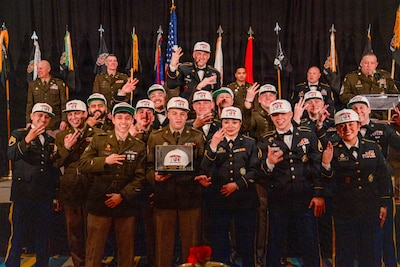 The Woodstock-based H Company “Honeybadgers” celebrate their “three-peat” as the Illinois Army National Guard Recruiting and Retention Battalion’s “Company of the Year” during the battalion’s annual awards banquet, Jan. 31, in Springfield.