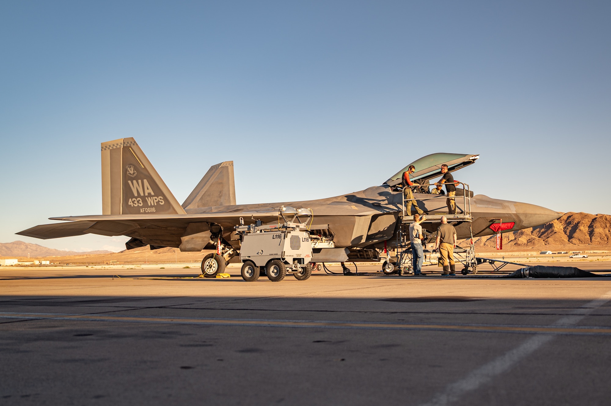 A military aircraft sitting on a flightline.