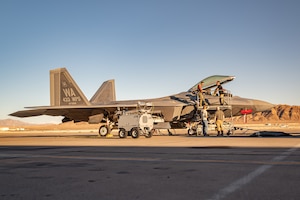 A military aircraft sitting on a flightline.