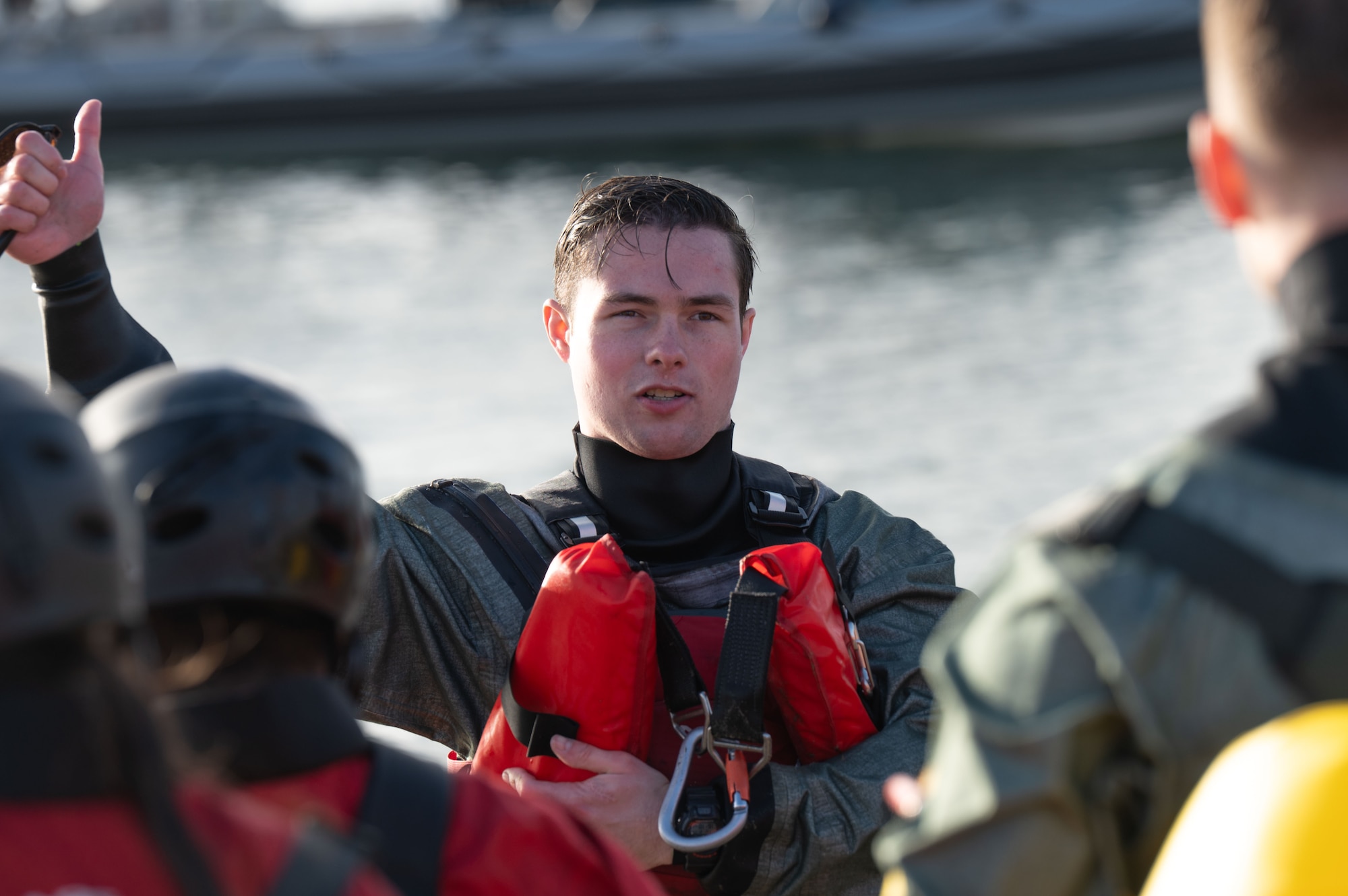U.S. Air Force Senior Airman Joshua Kappl, 3rd Operation Support Squadron survival, evasion, resistance and escape specialist, instructs participants after an open-water training scenario during Exercise Red Flag-Rescue at San Diego, California, Feb. 17, 2026. Participants demonstrated proficiency in water survival tactics, techniques and procedures. (U.S. Air Force photo by Airman 1st Class Jaden Kidd)