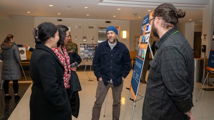 Members of Naval Surface Warfare Center, Carderock Division’s Electromagnetic Signatures Technology Division engage with attendees at a poster session in West Bethesda, Feb. 24, 2026.