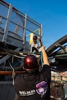 From top, Ryan Togami and Bronson Kimata, nuclear welders with Pearl Harbor Naval Shipyard and Intermediate Maintenance Facility, run a gas line to their job site in dry dock 1 at the shipyard Jan. 28, 2026.