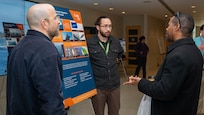 Members of Naval Surface Warfare Center, Carderock Division’s Electromagnetic Signatures Technology Division engage with attendees at a poster session in West Bethesda, Feb. 24, 2026.