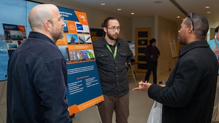Members of Naval Surface Warfare Center, Carderock Division’s Electromagnetic Signatures Technology Division engage with attendees at a poster session in West Bethesda, Feb. 24, 2026.