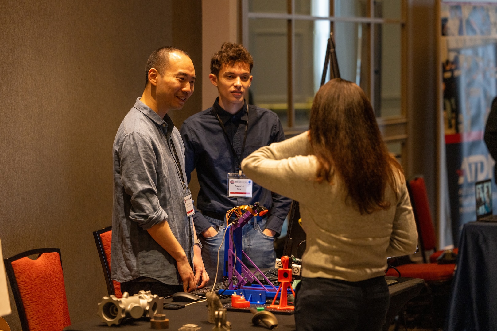 NORTH BETHESDA, Md. (Feb. 26, 2026) – University of Maryland students George Hwang, left, and Benicio Nix showcase their project, a 3D scanner mounted on a robotic arm, during the SIDE 2026: A Deep Dive into 3D Scanning industry partnership forum. The event, co-hosted by the Carderock Capital Tech Bridge and the Pike District Partnership, provided a platform for students to demonstrate their work and network with professionals from government, industry, and academia. Carderock, the Navy's innovation and ship design powerhouse, headquartered in West Bethesda, Maryland, is a world-class research and development facility specializing in critical ship and ship systems design.  (U.S. Navy photo by Aaron Thomas)