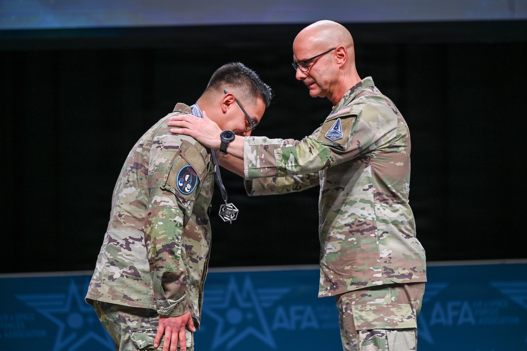 Guardians in uniform. Man accepts award and other places it over his neck