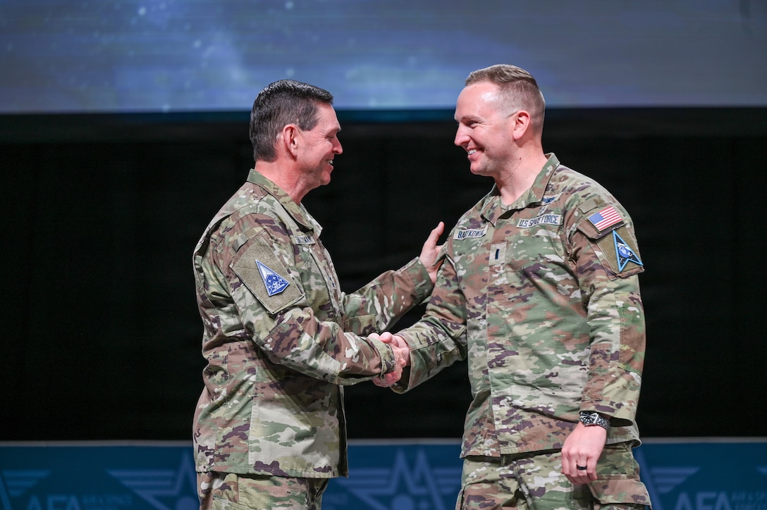 Guardians in uniform speaking at event with microphones and chairs