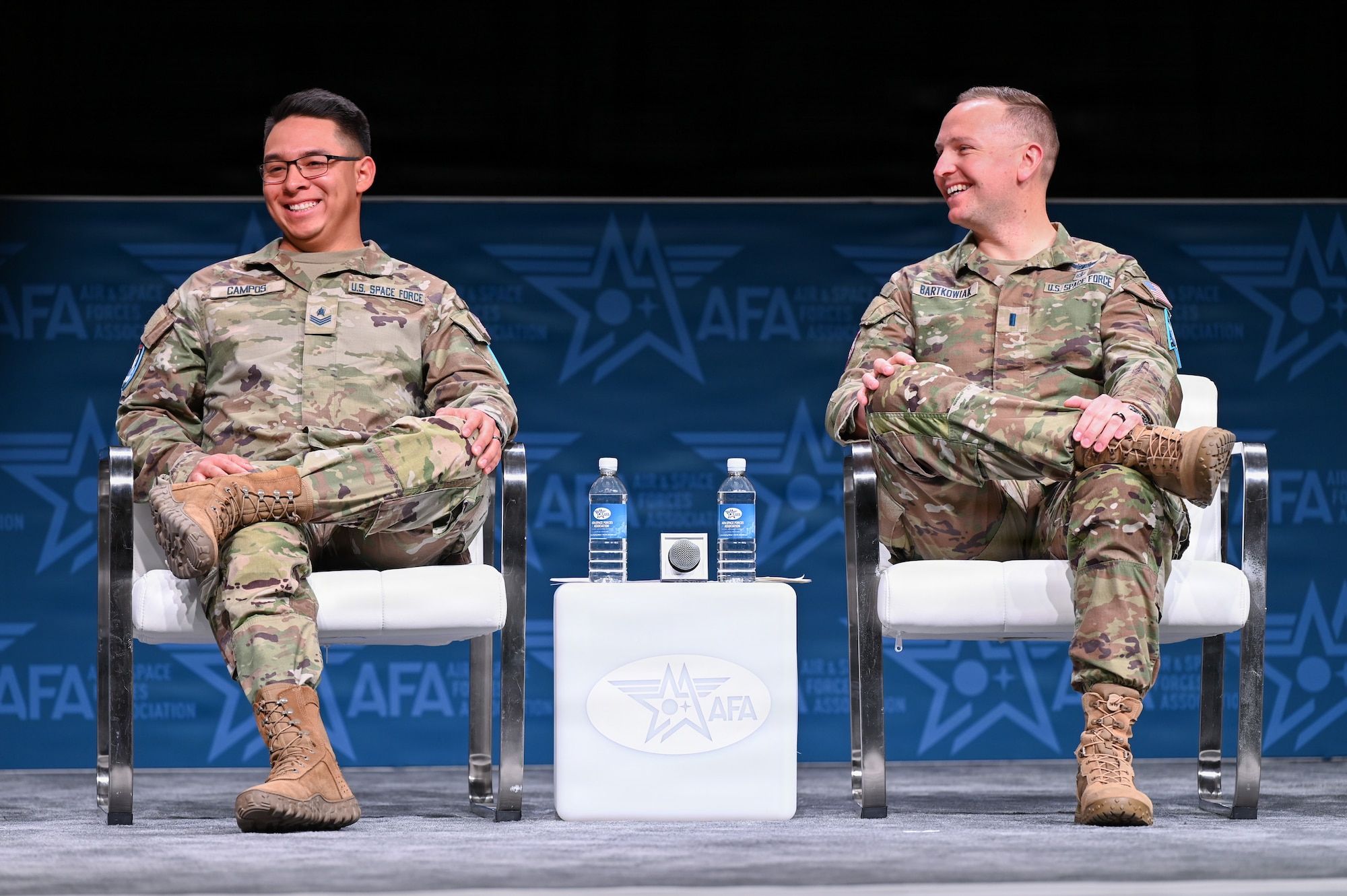 Guardians in uniform speaking at event with microphones and chairs