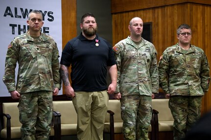 Staff Sgt. Christopher P. Kelnhofer stands at the position of attention during his retirement ceremony at the Illinois Military Academy in Springfield, Illinois, Feb. 22.