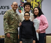 Lt. Col. Lionel Gonzalez and his family smile for a photo during his retirement ceremony at the Illinois Military Academy in Springfield, Illinois, Feb. 22.