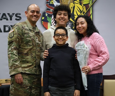 Lt. Col. Lionel Gonzalez and his family smile for a photo during his retirement ceremony at the Illinois Military Academy in Springfield, Illinois, Feb. 22.