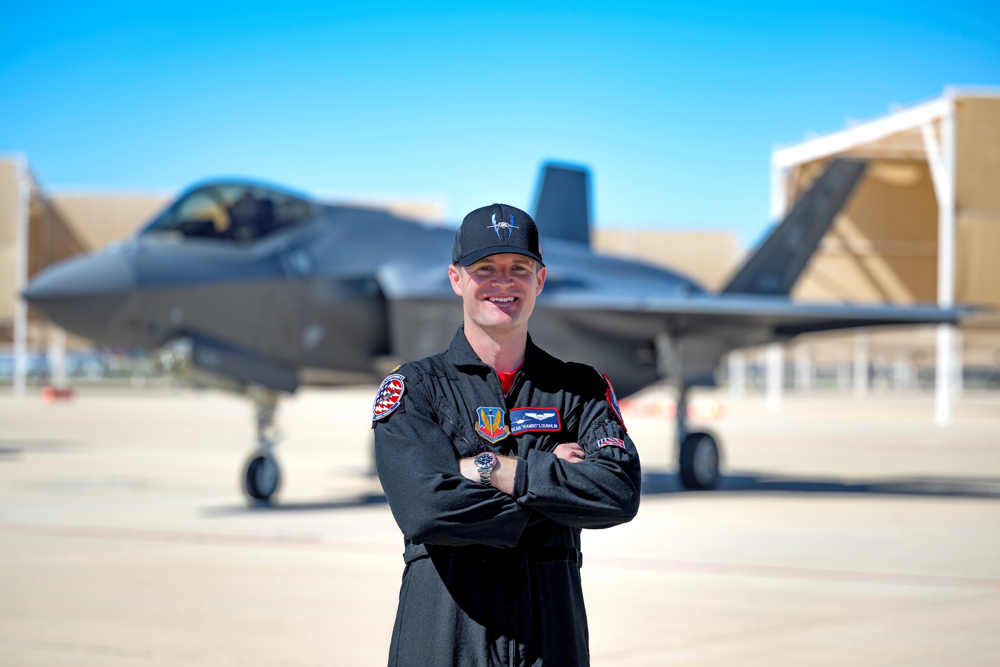 A photo of a pilot standing in front of an F-35