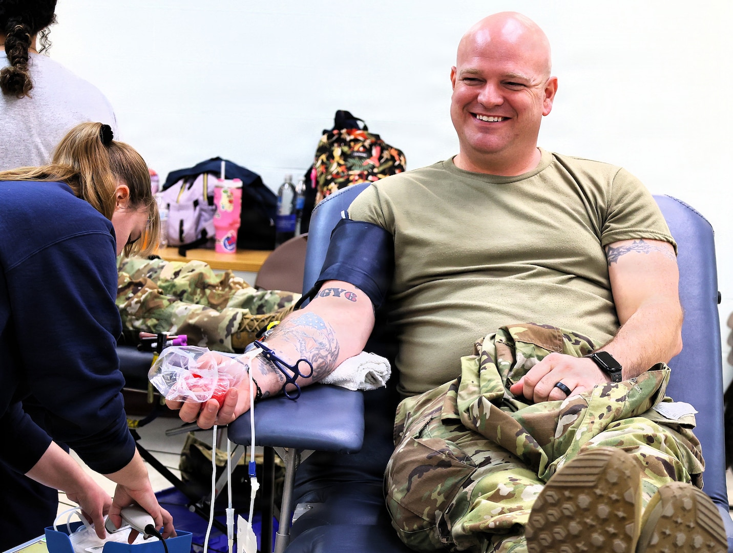 Illinois Army National Guard Sgt. 1st Class Joshua Webb of Galesburg's C Battery, 2nd Battalion, 123rd Field Artillery Regiment smiles as he prepares to let the blood flow for donation at the Illinois Army National Guard's armory in Milan.