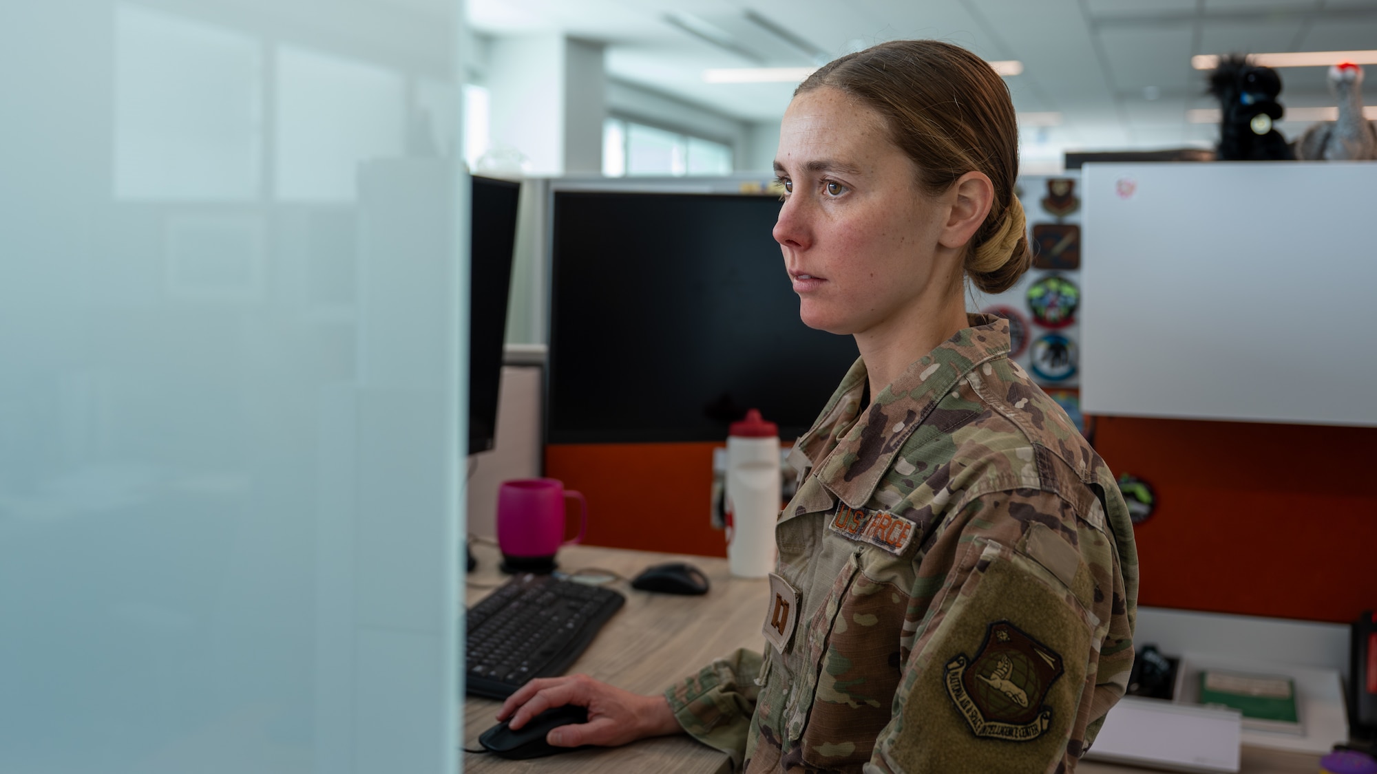 Capt. Jaci Smith, an Aircraft Analysis Squadron analyst, works at her desk at Wright-Patterson Air Force Base, Ohio, Feb. 20, 2026. Smith balances her duties as an intelligence officer with a rigorous training regimen as she prepares to represent the U.S. Armed Forces at the World Military Cross Country Championship in Greece. (U.S. Air Force photo by Staff Sgt. Kristof J. Rixmann)