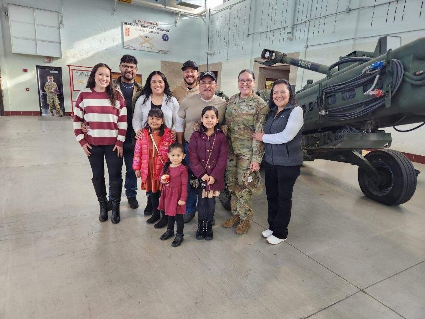 The family of Staff Sgt. Daniela Martinez pose for a photo after her promotion ceremony.