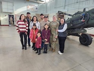 The family of Staff Sgt. Daniela Martinez pose for a photo after her promotion ceremony.