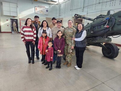 The family of Staff Sgt. Daniela Martinez pose for a photo after her promotion ceremony.