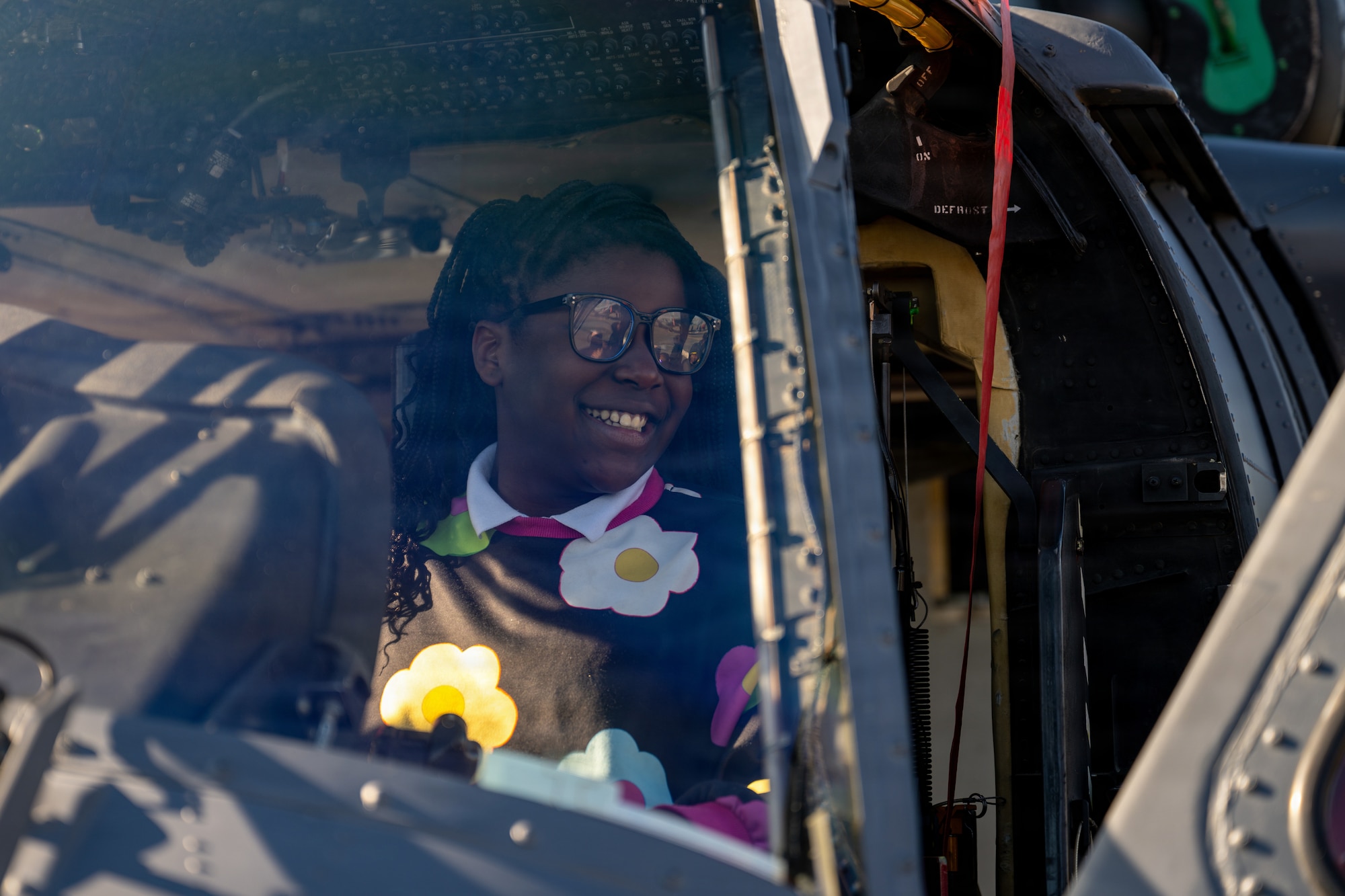 A student from the local area sits inside an HH-60W Jolly Green II at a static display during Saluting Our Aviation Roots week at Moody Air Force Base, Georgia, Feb. 24, 2025. Students were able to learn about the Air Force capabilities and mission during SOAR week. (U.S. Air Force photo by Airman 1st Class Rachel Howell)