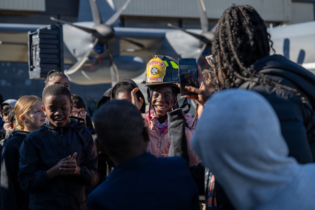 A student tries on a fireman’s helmet during Saluting Our Aviation Roots (SOAR) Week at Moody Air Force Base, Georgia, Feb. 24, 2026. The day before, students across the local area were visited by Moody Airmen to familiarize them with their jobs and answer questions. (U.S. Air Force photo by Airman 1st Class Rachel Howell)