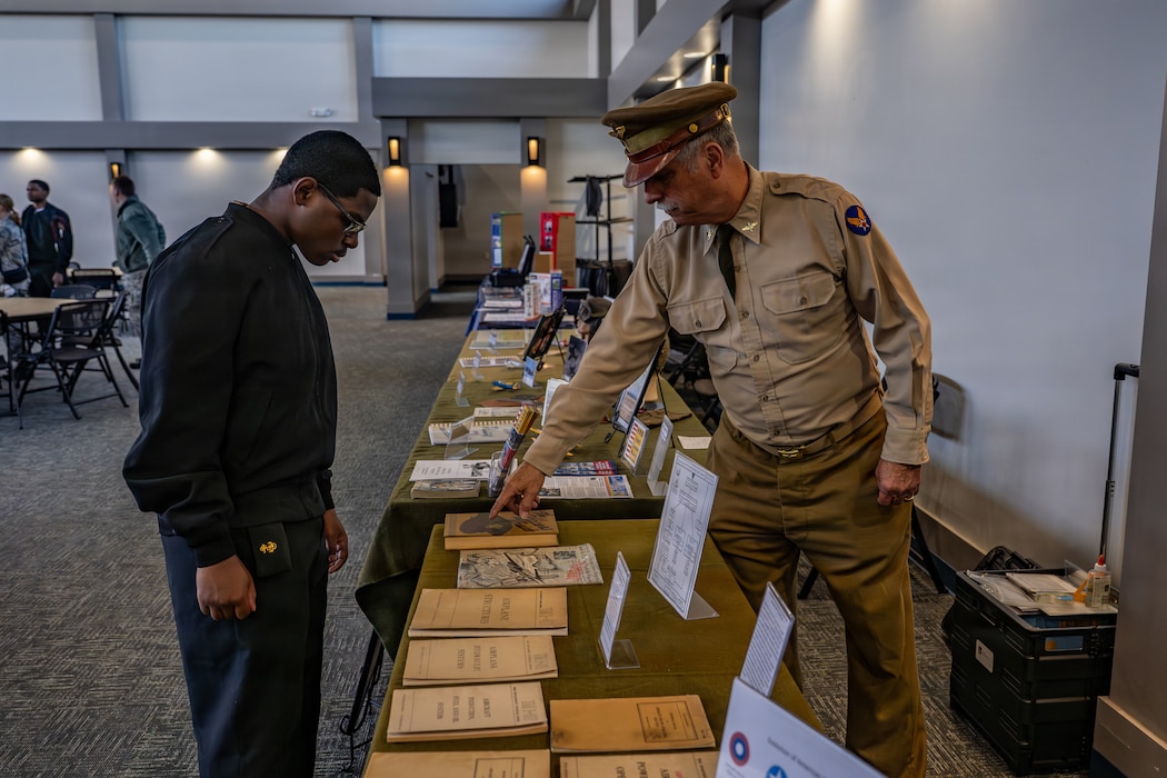 Retired U.S. Air Force Lt. Col. Timothy Oliver, a World War II Flight Training Museum docent, speaks with a local Junior ROTC student about the museum during Saluting Our Aviation Roots (SOAR) Week at Moody Air Force Base, Georgia, Feb. 24, 2026. He highlighted the museum’s role in preserving aviation heritage and educating future generations about the legacy of military flight training. (U.S. Air Force photo by Senior Airman Savannah Carpenter)