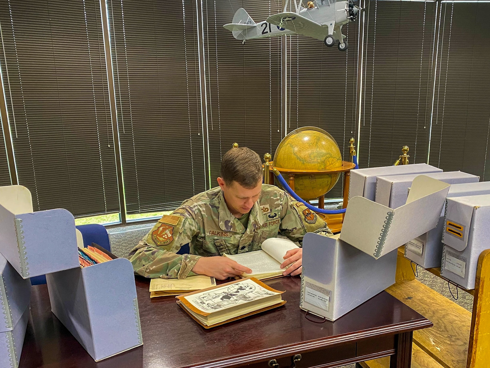 U.S. Air Force Lt. Col. William Calkins, Officer Training School instructor, reads through historical documents in a reading room at Maxwell Air Force, Alabama, Feb. 27, 2026.